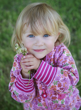 photo: little girl with flowers in her hand